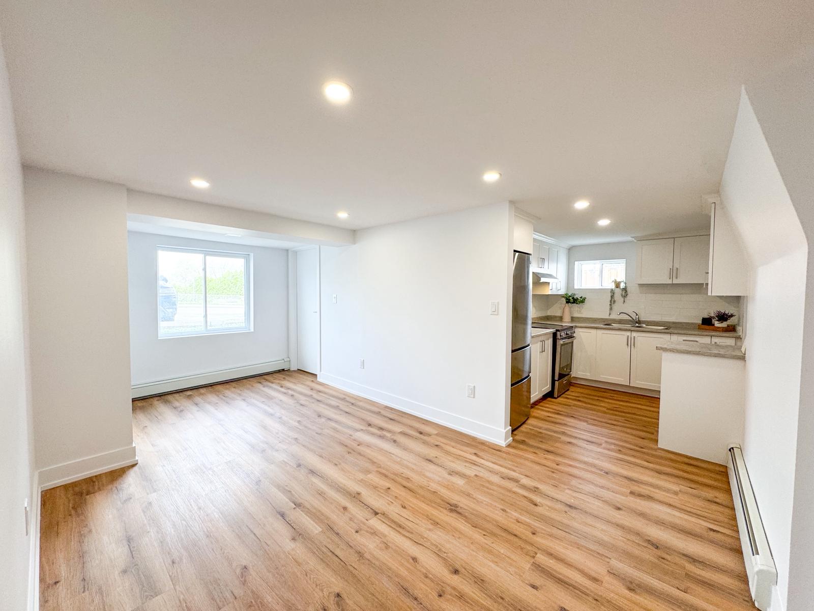 Open concept living room and kitchen in finished basement suite